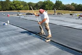Man applying EPDM roofing material