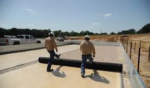 Workers laying down construction material
